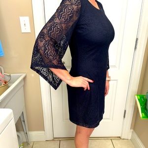 A. Buyer size Medium Navy lace dress with sheer lace 3/4 sleeves.